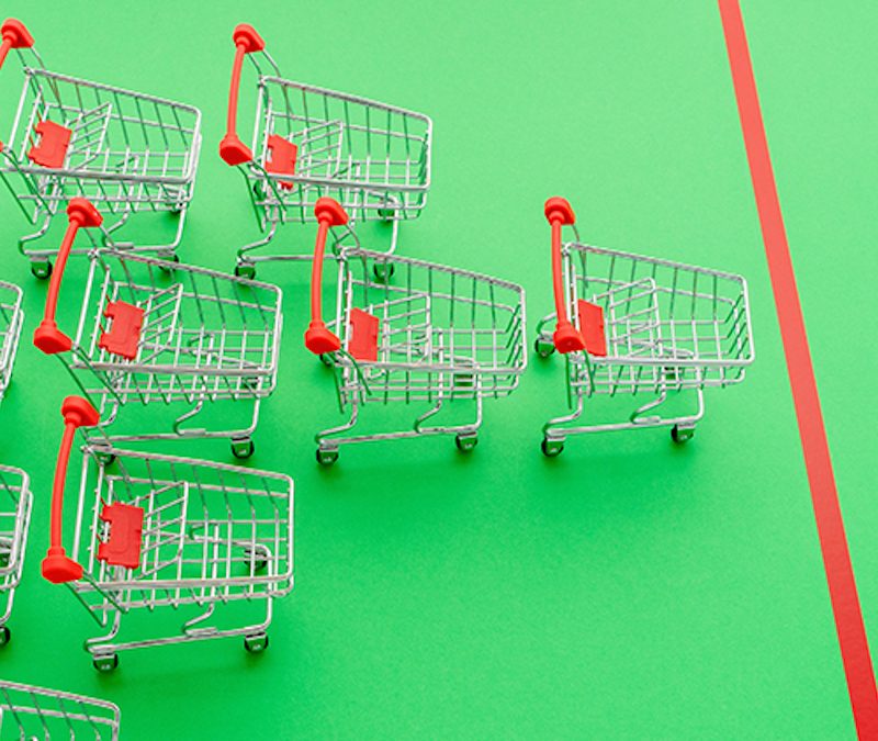 green field with one red finish line and a bunch of shopping carts